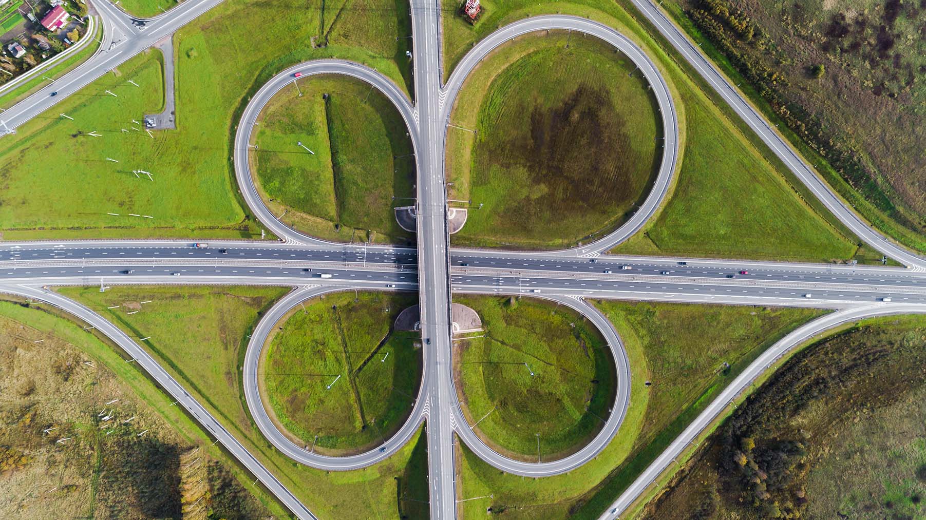 areal-shot-of-new-motorway-junction-on-green-land